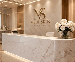 Medi Skin Academy marble reception with champagne details and white flowers